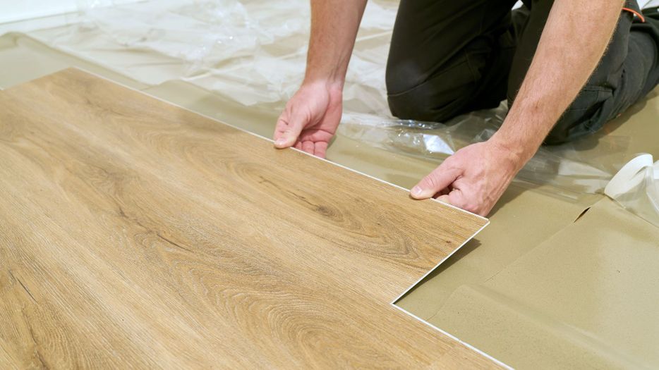 person installing LVP flooring