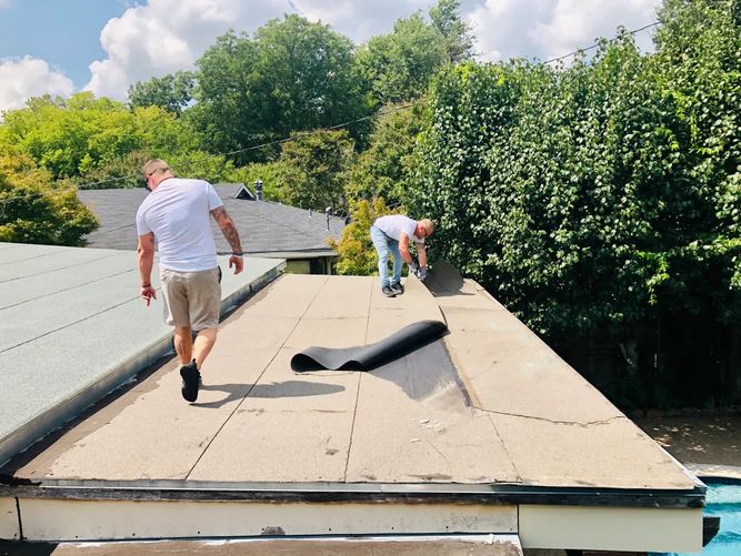 Roofing workers working on a commercial roof