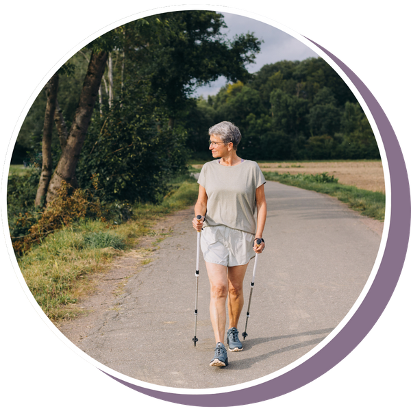 a mature woman peacefully walking with walking sticks