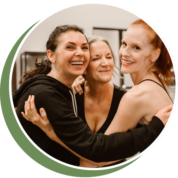 three women hugging together smiling