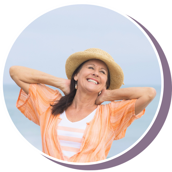 a mature woman smiling on the beach