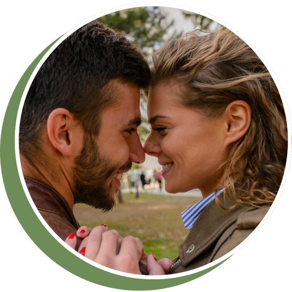 smiling couple leaning foreheads together