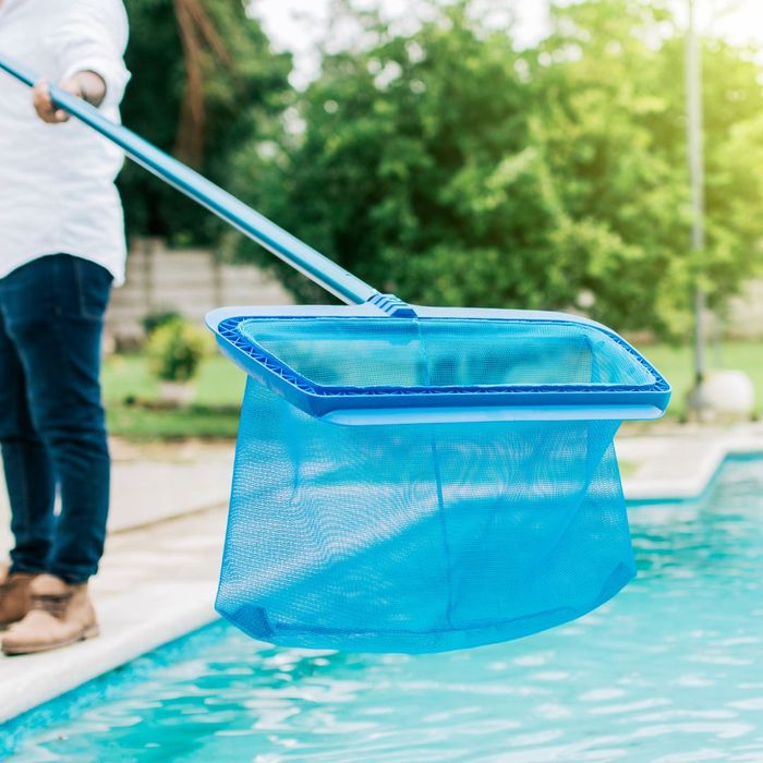 person cleaning pool