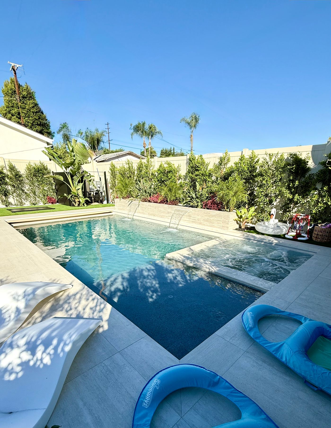 Woodland Hills pool with Baja step, raised wall water features, and integrated spa.