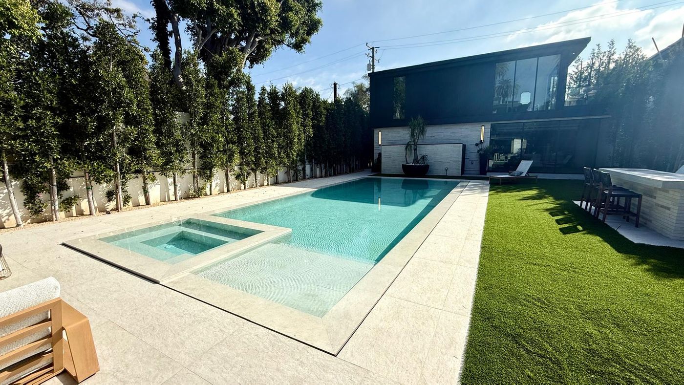 zero edge pool with white pebble finish santa monica
