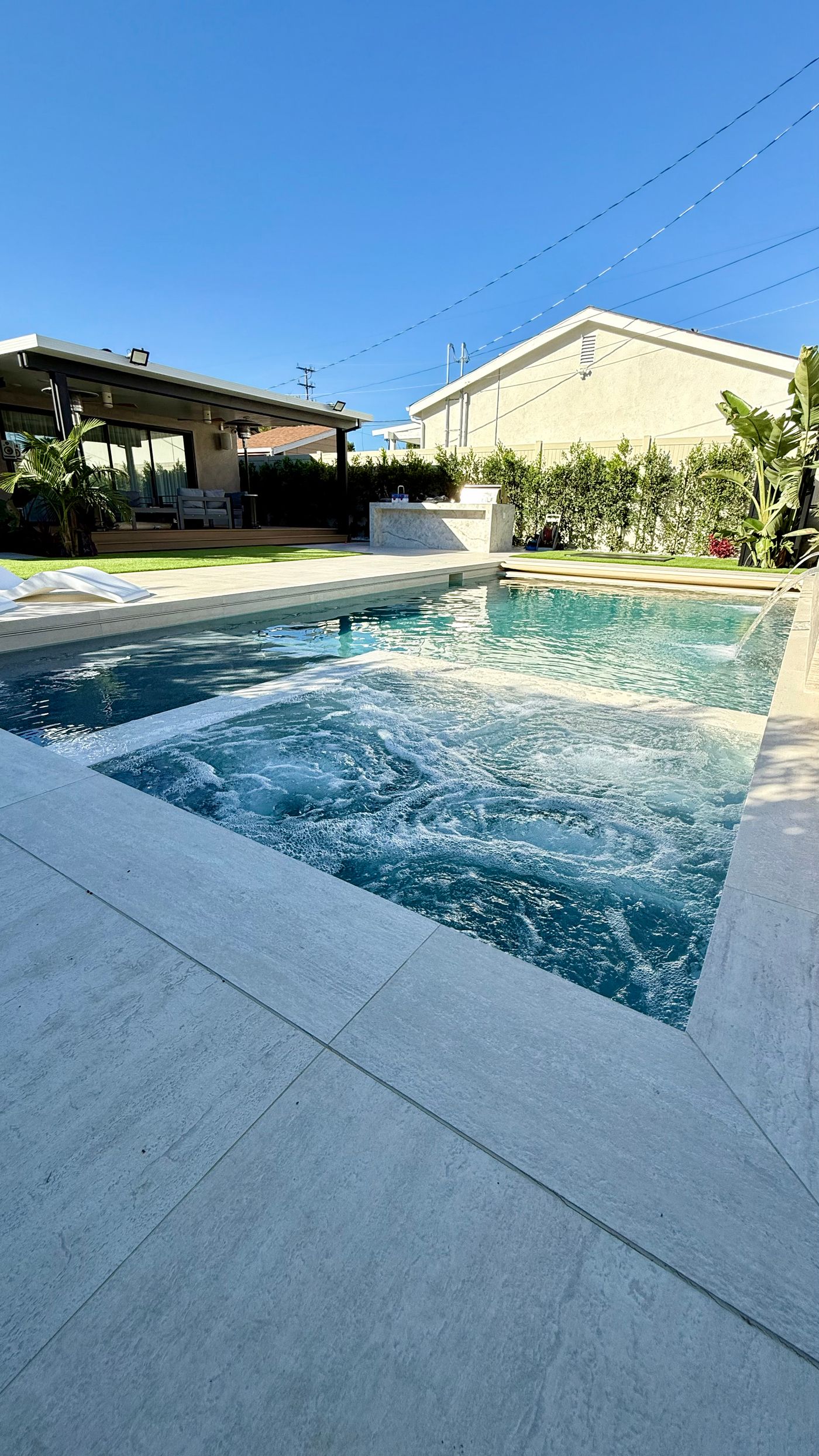 jets next to modern pool in Woodland Hills backyard remodel.