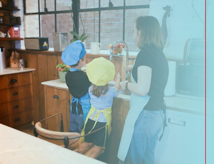 Young children at a kitchen sink.