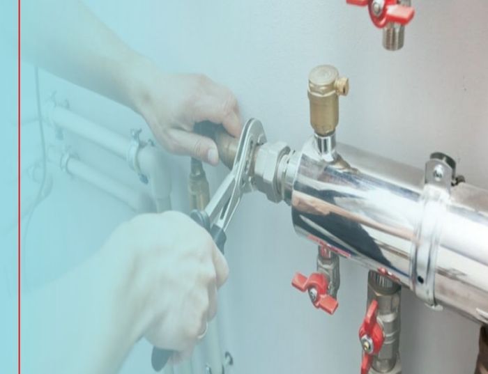 working on service line with wrench 