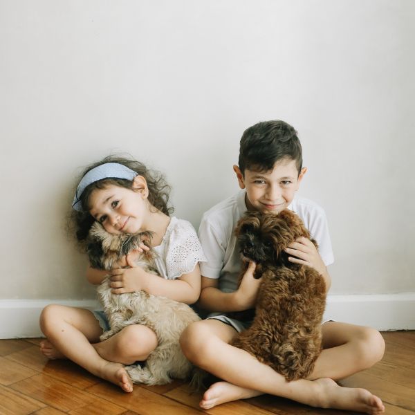 Two children holding their pets. Two children holding their pets.