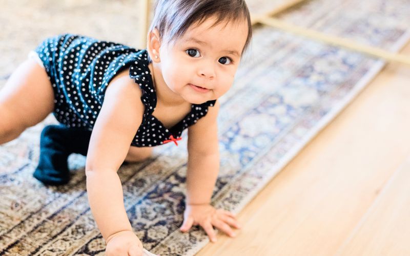 baby crawling on area rug that has been professionally cleaned 