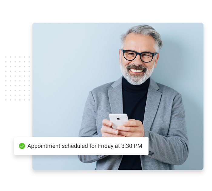 Smiling man with phone overlaid with a checkmark that says 'Appointment scheduled for Friday at 3:30 PM' Chiropractic scheduling software