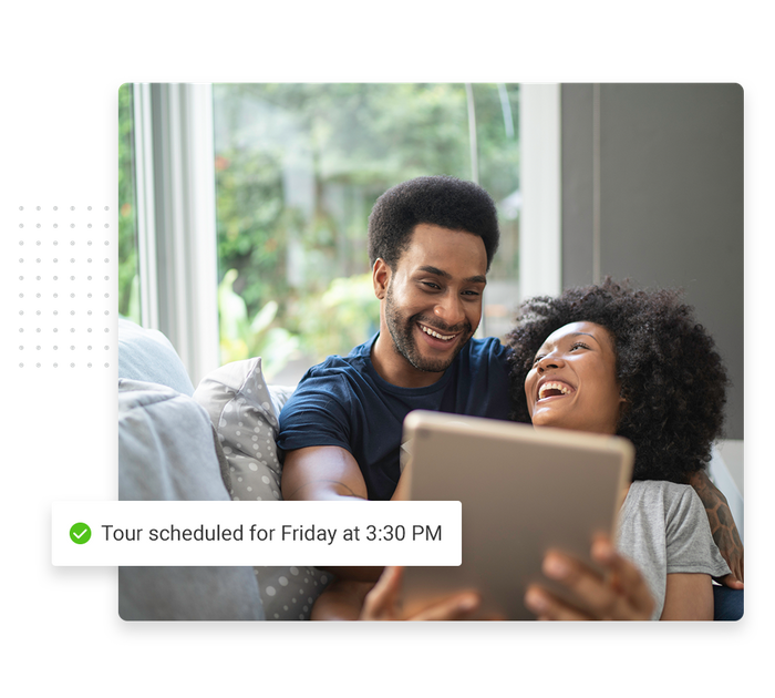 Smiling couple with tablet overlaid with a checkmark that says 'Tour scheduled for Friday at 3:30 PM' venue scheduling software