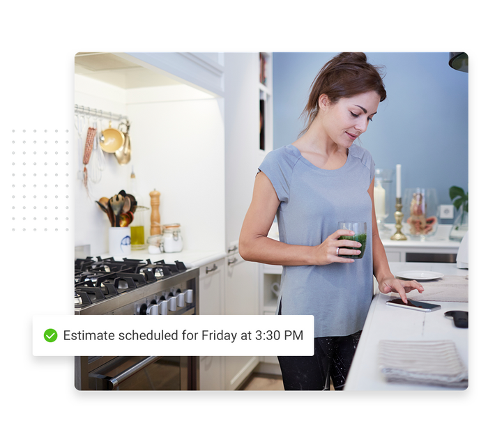 A woman in a kitchen looks at a phone overlaid with a checkmark that says 'Estimate scheduled for Friday at 3:30 PM' House cleaning scheduling software