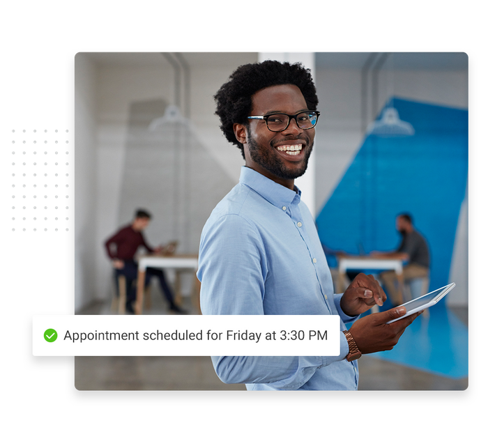 Smiling man with a tablet overlaid with a checkmark that says 'Appointment scheduled for Friday at 3:30 PM' Optometrist scheduling software