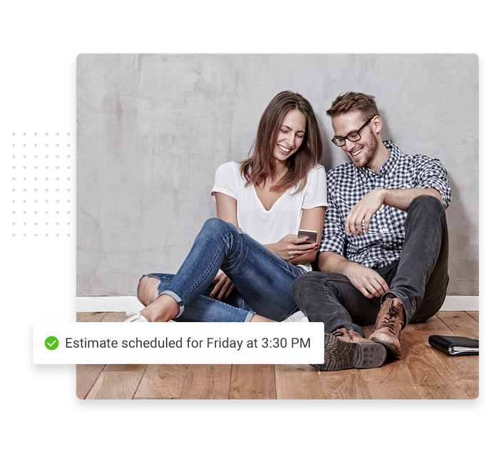Couple sitting on floor looking at smartphone overlaid with a checkmark that says 'Estimate scheduled for Friday at 3:30 PM' Flooring scheduling software