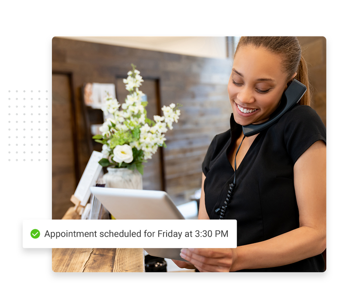 Woman on phone with a tablet overlaid with a checkmark that says 'Appointment scheduled for 3:30 PM' spa scheduling software