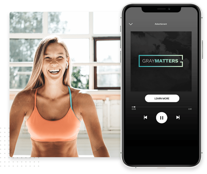 Smiling woman in Barre class overlaid with digital ad Spotify advertising