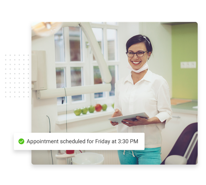 Smiling dentist in office overlaid with a checkmark that says 'Appointment scheduled for Friday at 3:30 PM' Dentist scheduling software