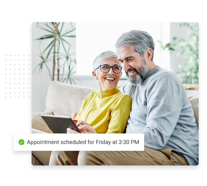 Older couple looking at tablet overlaid with a checkmark that says 'Appointment scheduled for Friday at 3:30 PM' therapist scheduling software