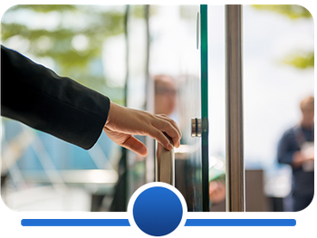 Image of a hand opening a door to a business