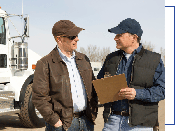 man holding clipboard by truck