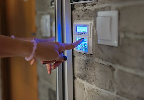 woman pushing buttons on a security key pad