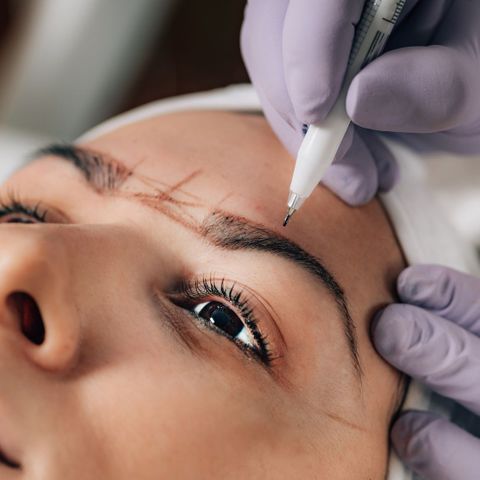 a woman getting her eyebrows microbladed Kickstart Your Beauty Career 1.jpg