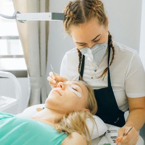 a woman giving another woman eyelash ectensions Kickstart Your Beauty Career 2.jpg