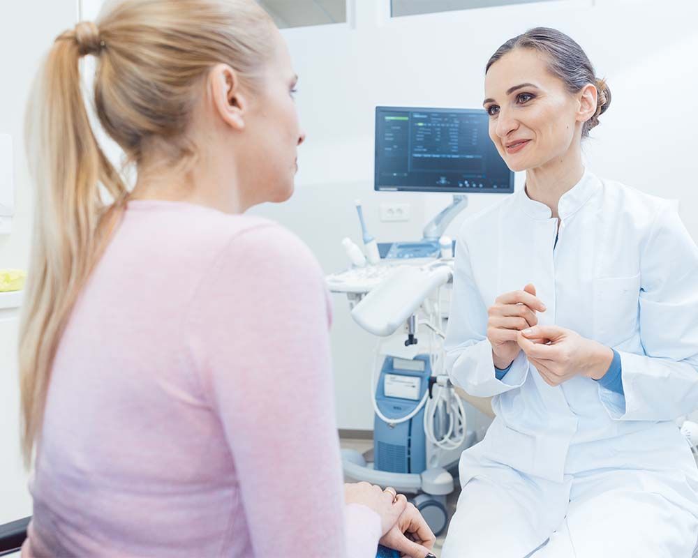 a doctor talking with a patient in an exam room
