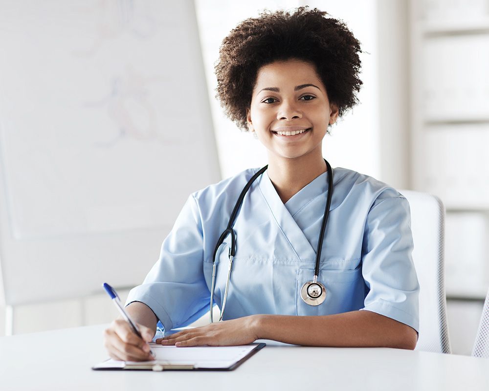 a nurse with a stethoscope writing on a chart