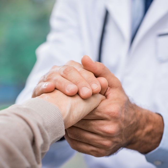 Doctor holding a patient's hand