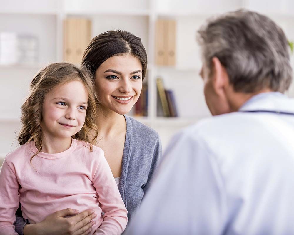 a doctor talking with a child and mother