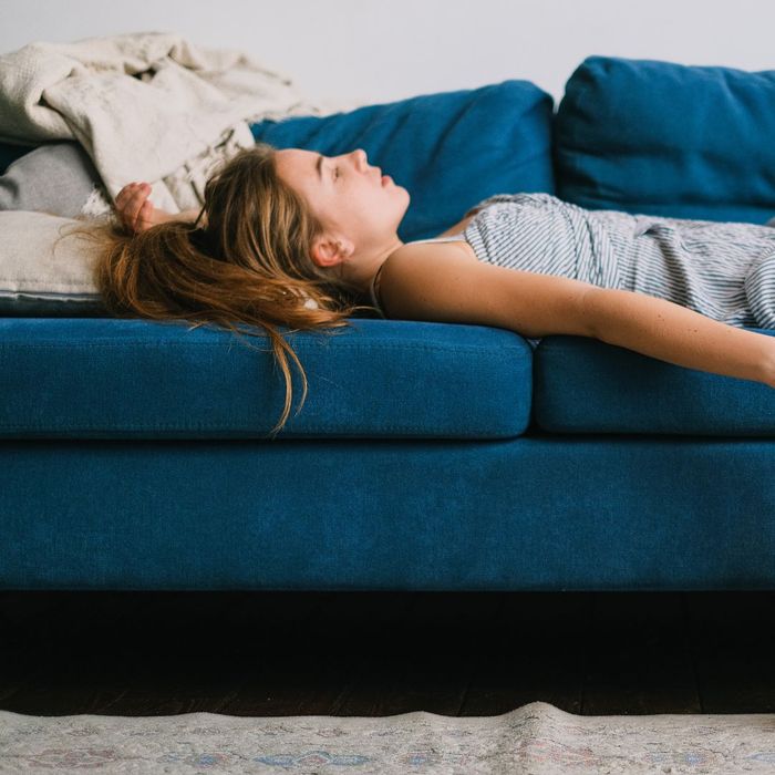 fatigued woman laying on a couch