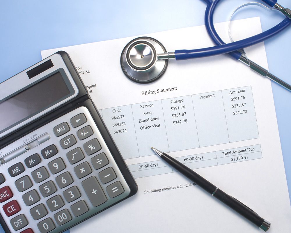 a stethoscope and calculator on top of a bill
