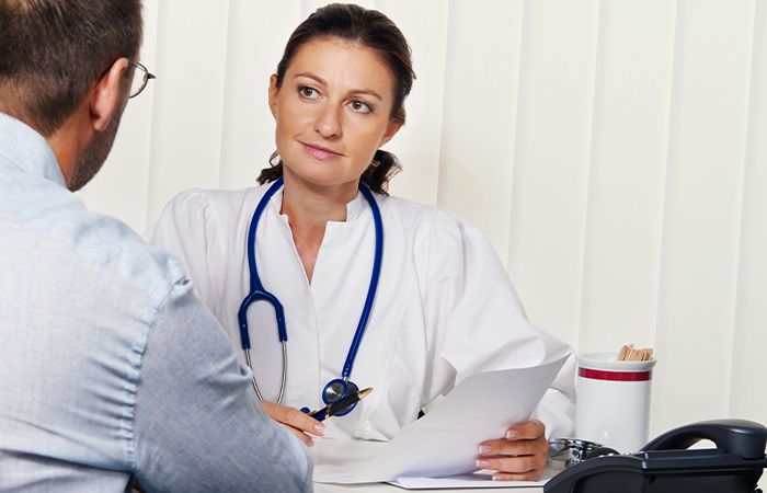 a doctor looking at paperwork with a patient