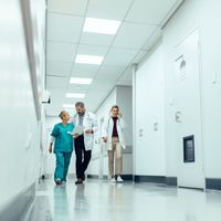 group of medical professionals talking while walking