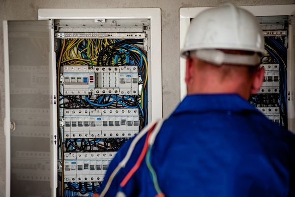 electrician standing infront of electrical panel