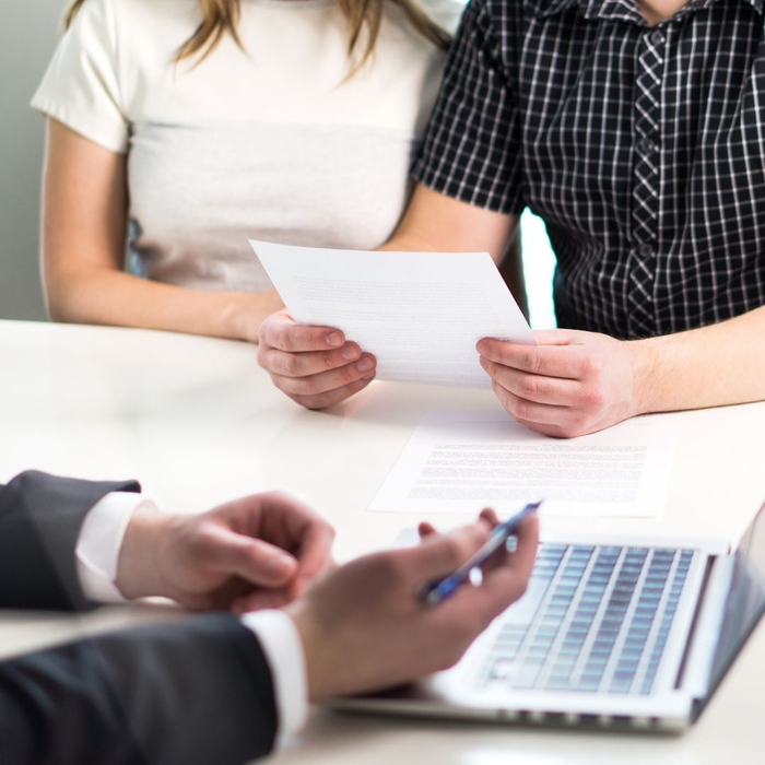 claims adjuster denying claim while talking to couple