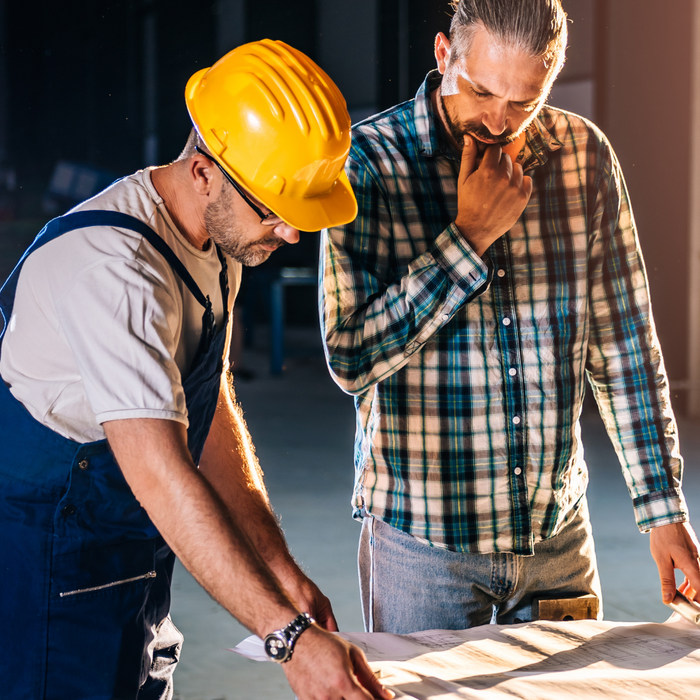 men looking at building plans men looking at building plans
