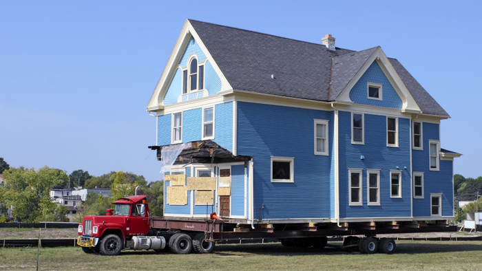 large blue house being relocated