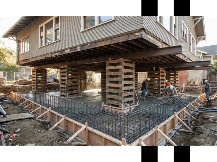 concrete foundation being formed beneath a raised home