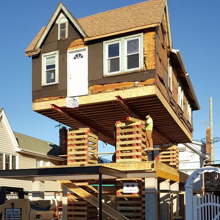 Ironmen workers lifting a home