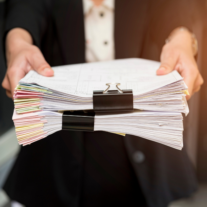person holding documents person holding documents