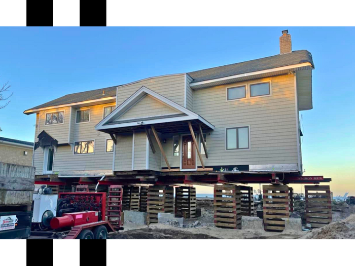 a home on the beach being lifted