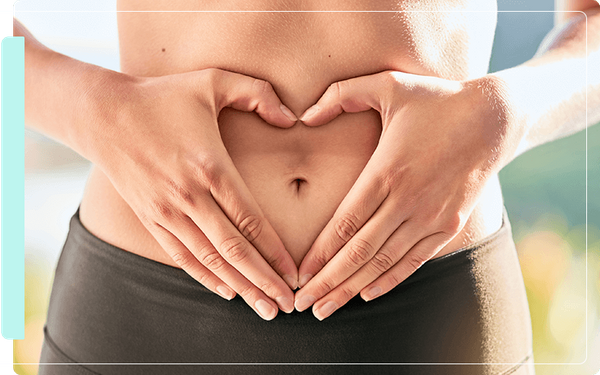 image of a woman doing heart hands on her stomach