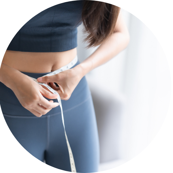 woman measuring waist with measuring tape