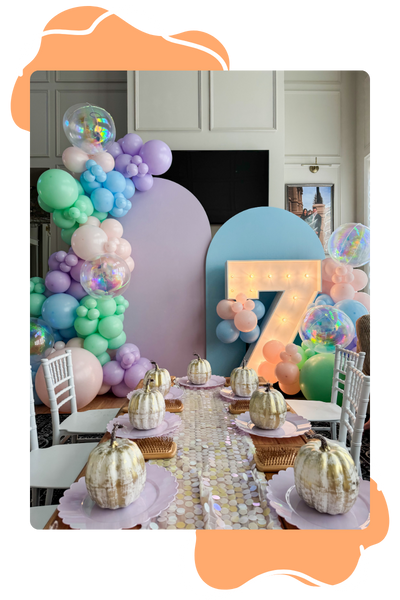 seven year old birthday party with marquee and balloon arch backdrop