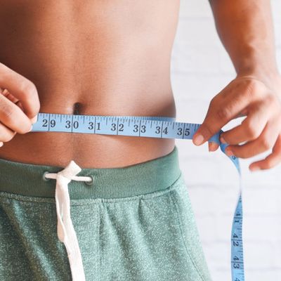 male belly with tape measure