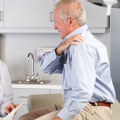 older male with shoulder pain at doctor