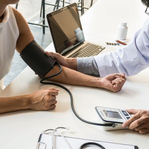 nurse taking man's blood pressure